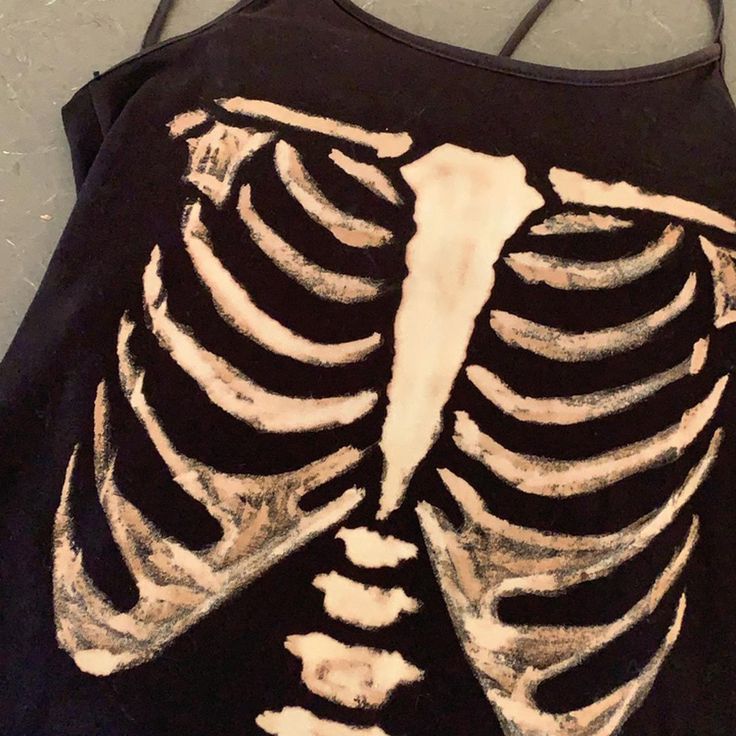 a black shirt with a skeleton painted on it