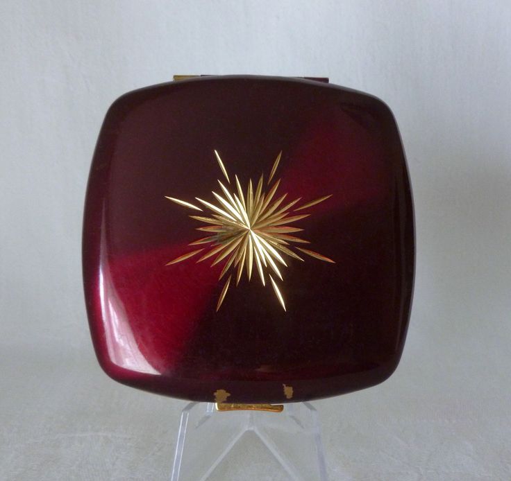 On offer is this vintage powder compact by Melissa. The lid is a gorgeous glossy deep red colour with a central diamond cut goldtone starburst design. Inside the compact, which opens with a press of a button, is an original sifter. The compact is stamped 'Melissa Made in England' just below the mirror. The compact measures approximately 3 inches (7.5cms) square. Condition: The compact is in very good condition overall, with just a couple of small chips on the lid above the clasp. The mirror is c I Am Very Sorry, Starburst Design, Powder Compact, Vanity Storage, Very Sorry, Deep Red Color, Red Colour, Toiletry Storage, Diamond Cut