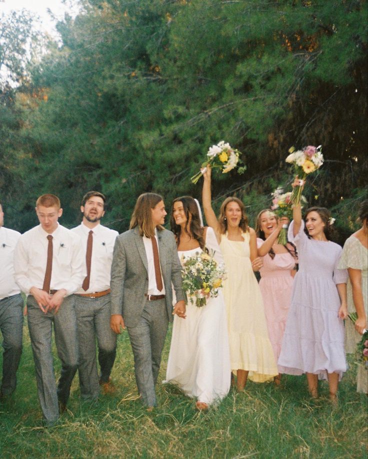 a group of people that are standing in the grass