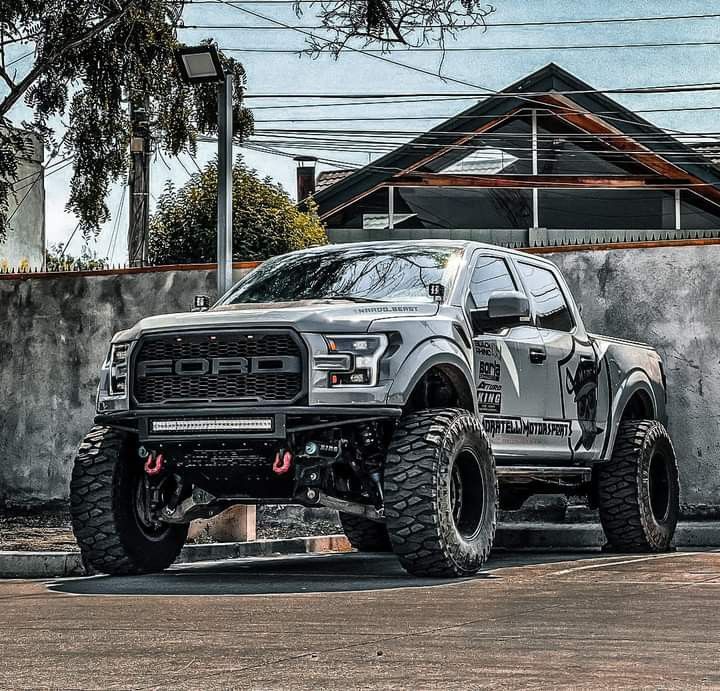 a silver truck parked in front of a building