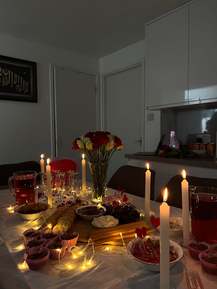 a table topped with lots of food and lit candles