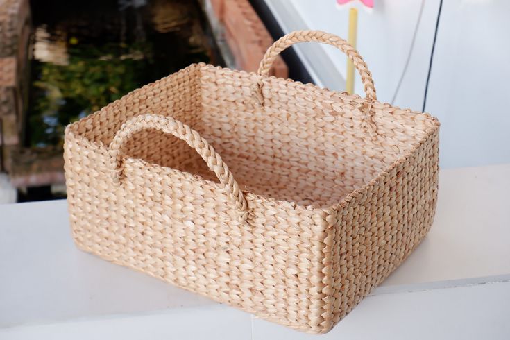 a wicker basket sitting on top of a white counter