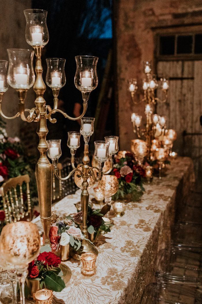 a table topped with lots of candles and flowers