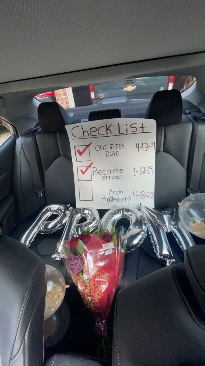 the back seat of a car with a sign on it that says check list our first date