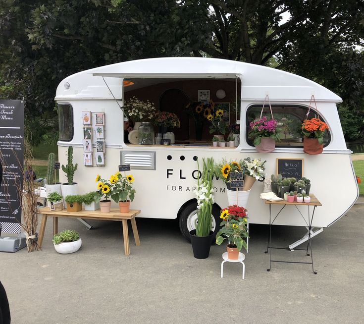 a food truck with flowers and plants on display