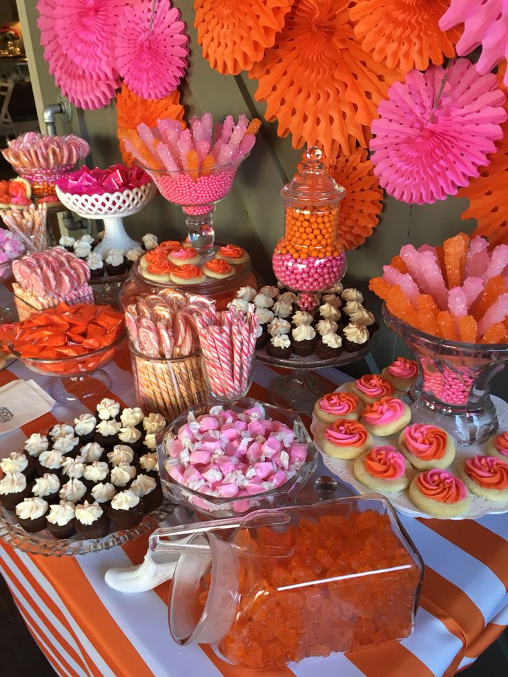 a table topped with lots of candy and cupcakes