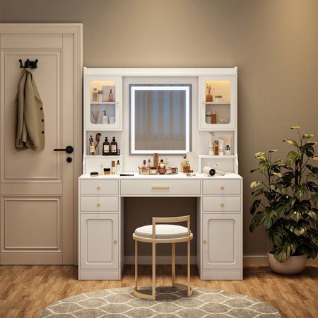 a white vanity with mirror and stool in a room