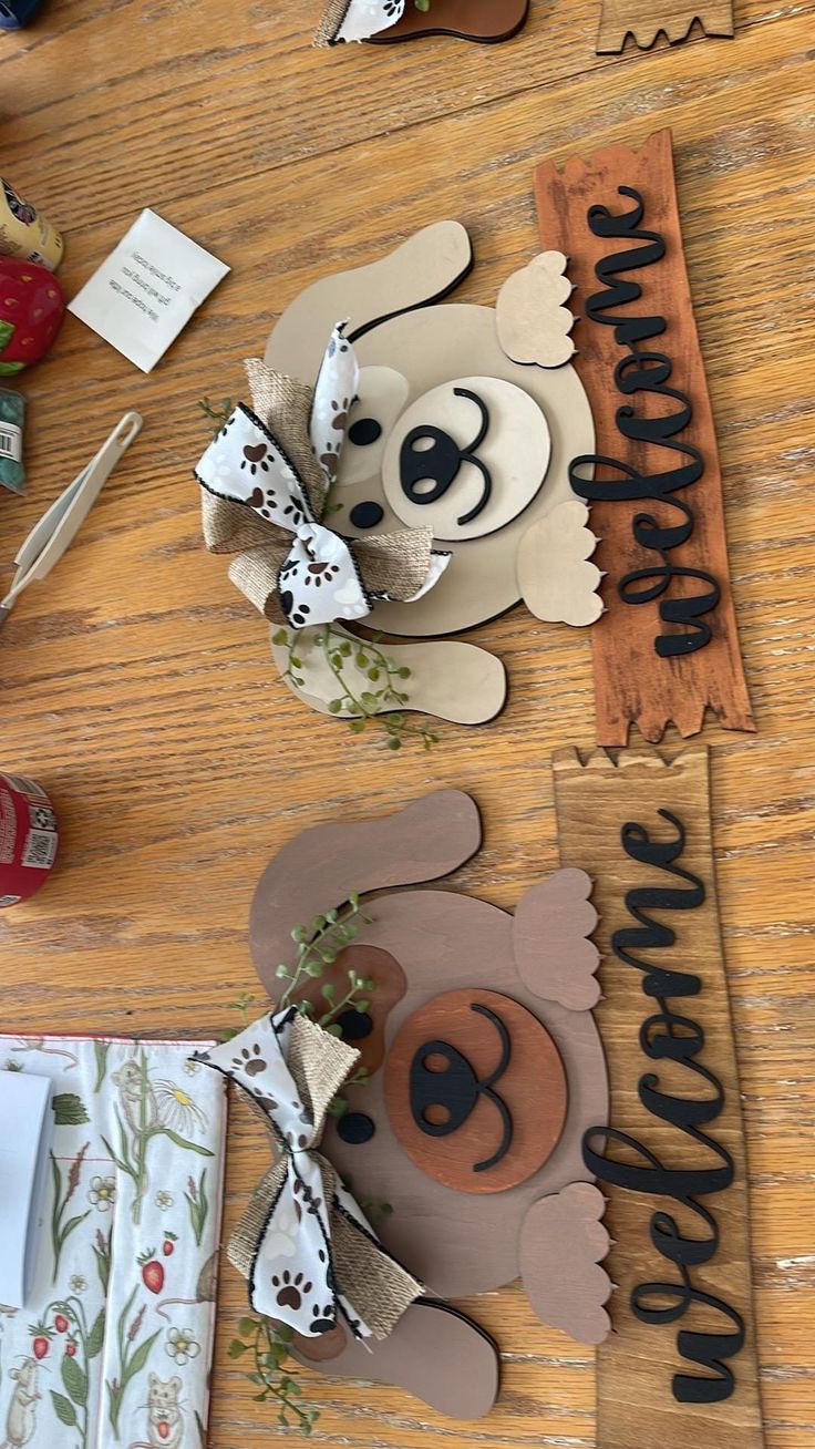 a wooden table topped with paper cut out animals and flowers on top of each other