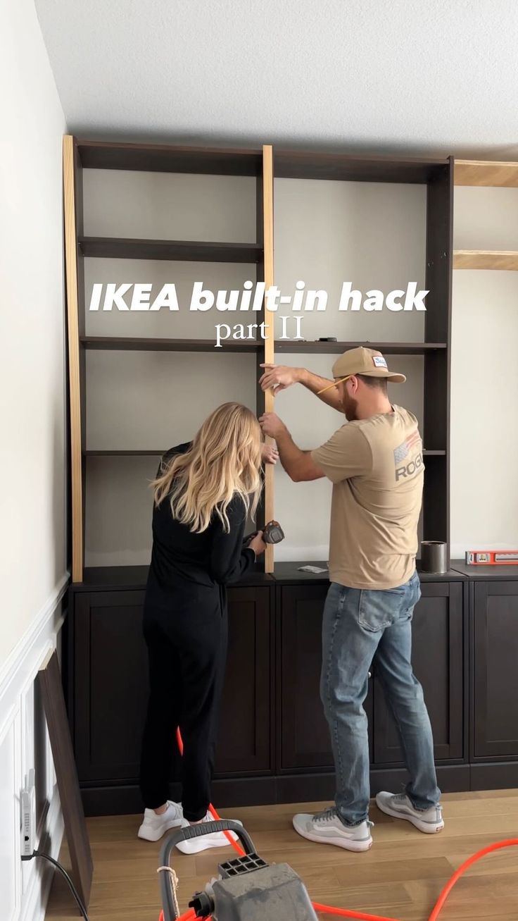 a man and woman standing in front of a bookshelf with the words ikea built - in hack on it