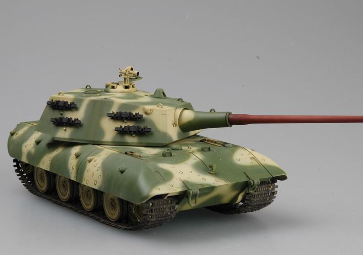 a toy tank with a red handle on it's tip is shown in front of a gray background