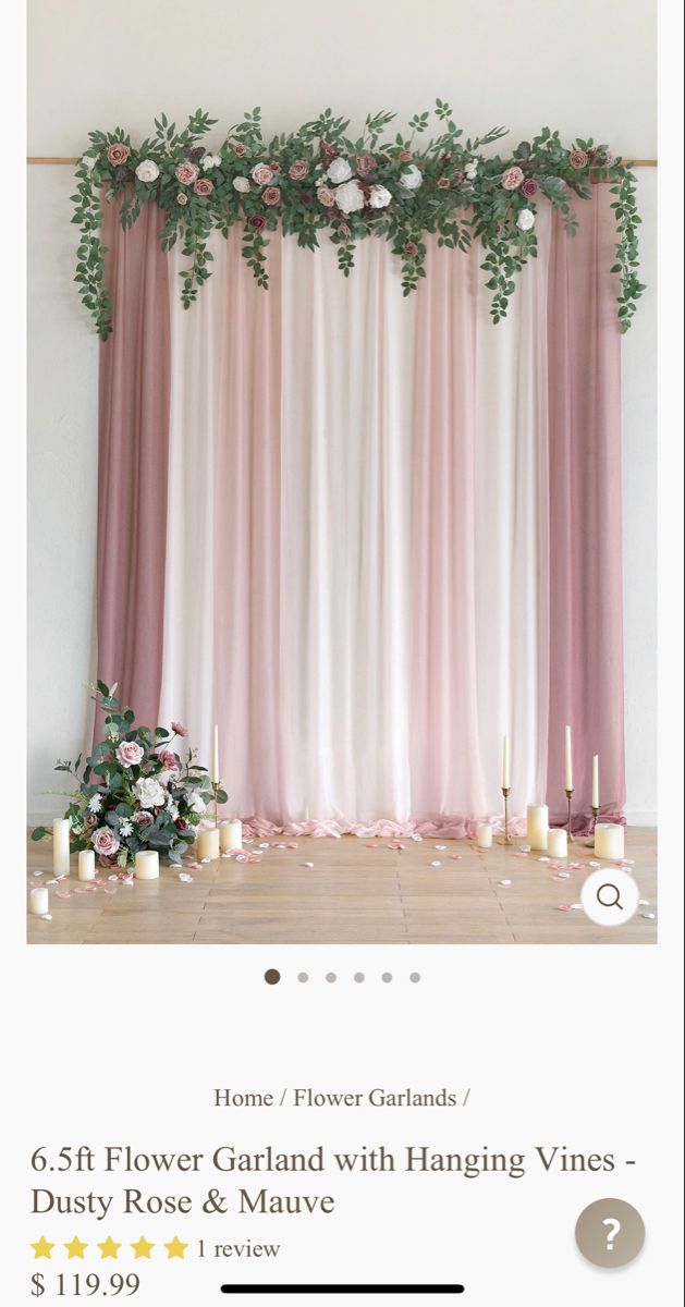 an image of flowers and candles in front of a curtain with pink drapes on it