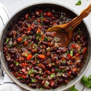 a pot filled with beans and garnished with cilantro