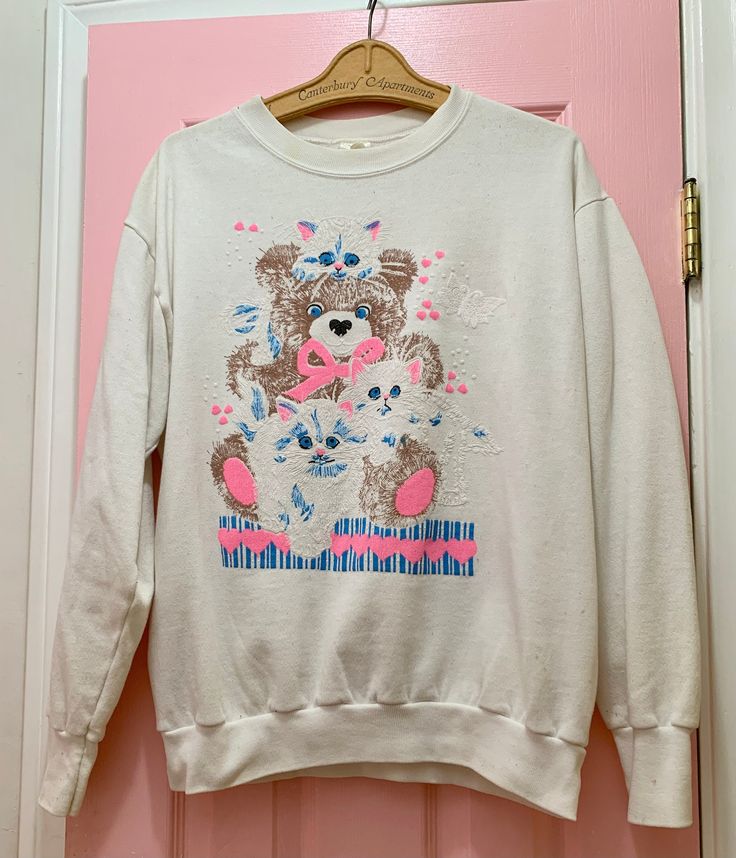 White vintage sweatshirt with fluffy kittens  and a teddy bear. Marked Steinwurtzel size XL but cute as a looser sweatshirt too and fits more like a current M/L. Model is a size 2/4, S. From the 1980s/early 90s. Very good condition. Minor discolorations (see photos) The sweatshirt is comfy and too cute. Teddy Bear Graphic, Fluffy Kittens, A Teddy Bear, Bear Graphic, Early 90s, Kitty Cat, Vintage Sweatshirt, White Vintage, Cats And Kittens