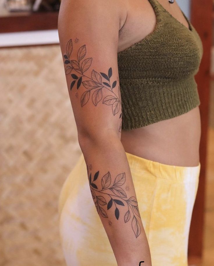 a woman with a flower tattoo on her arm