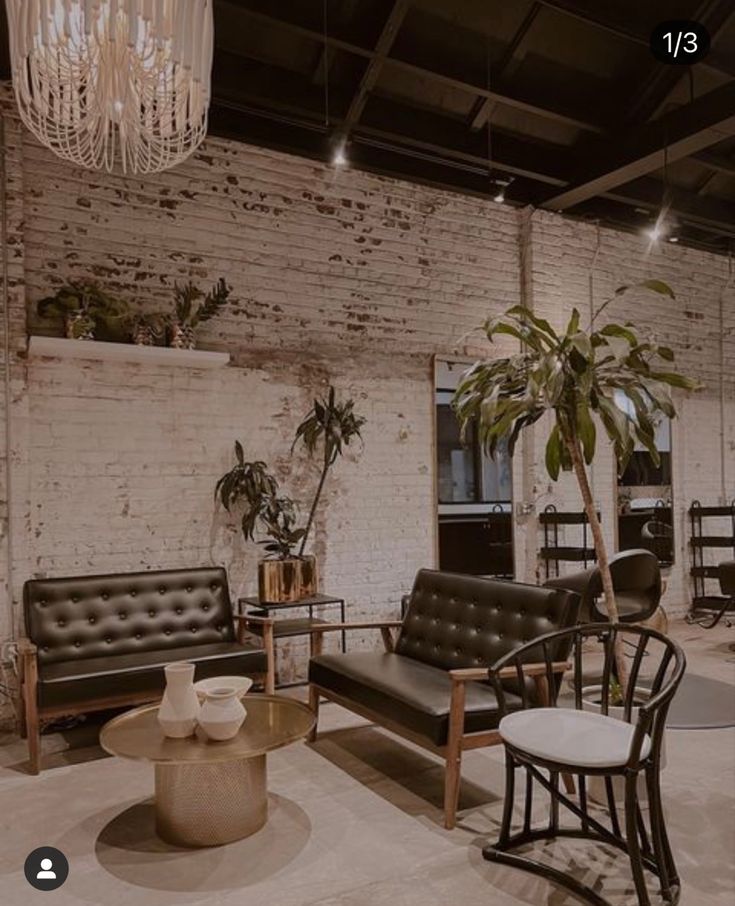 a living room filled with lots of furniture and a chandelier hanging from the ceiling