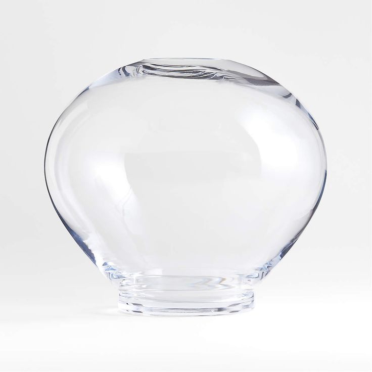 a clear glass vase sitting on top of a white table