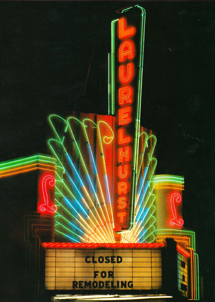 an old theater sign with neon lights on it's sides and the words closed for remodeling