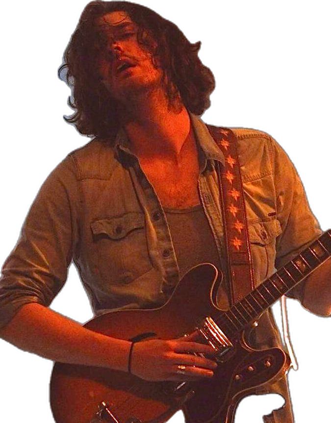 a man with long hair playing an electric guitar