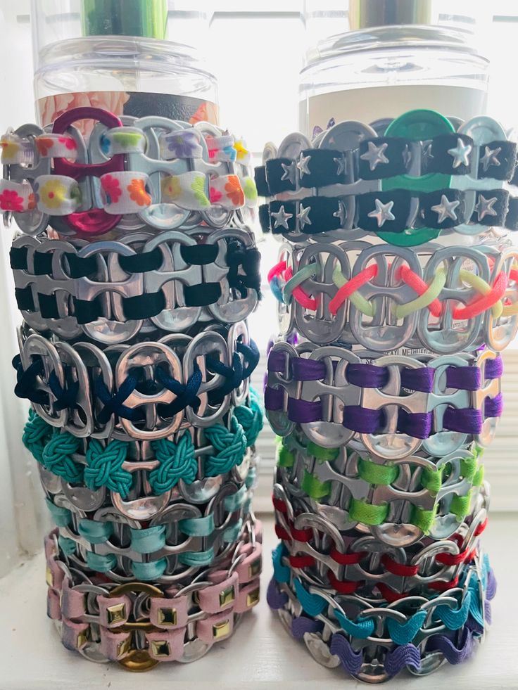 two stacks of bracelets sitting on top of a window sill next to each other