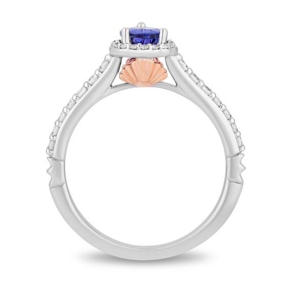 a white gold ring with an orange and blue stone in the center, surrounded by diamonds