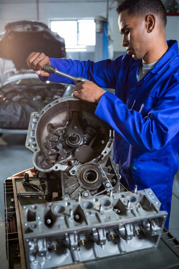 a man working on an engine in a garage