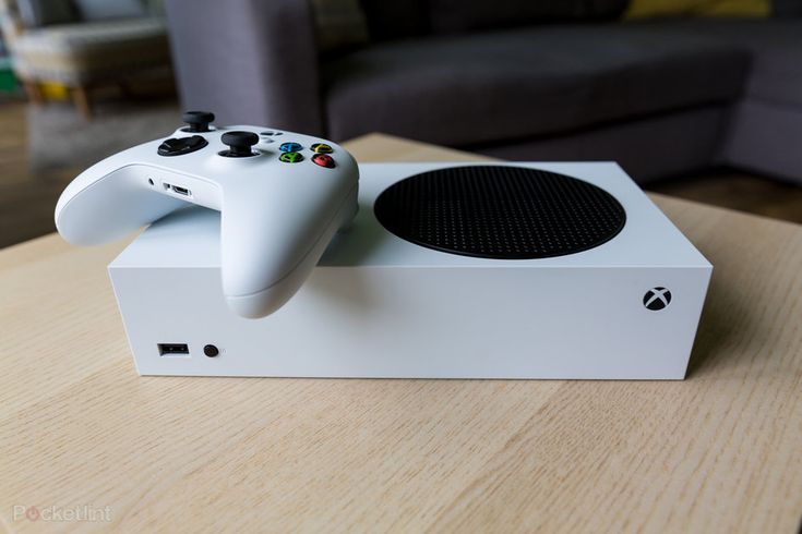 a video game controller sitting on top of a white box