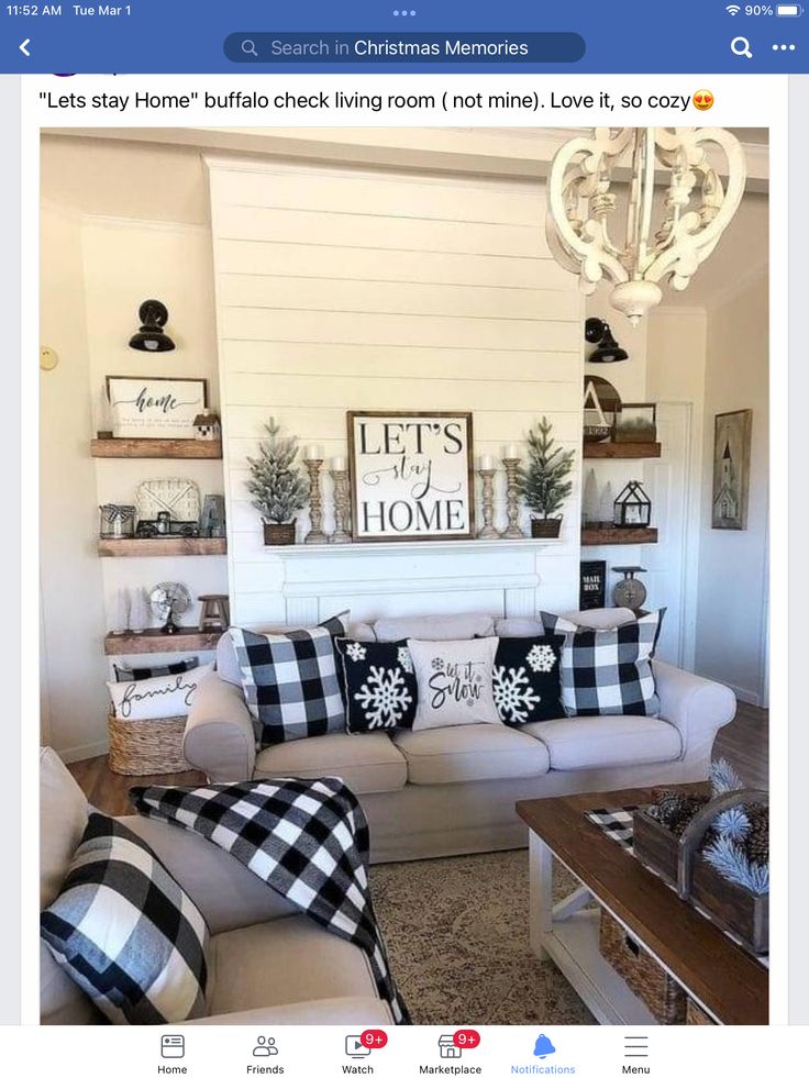 the living room is decorated in black and white checkered pillows, plaid throw pillows, wood