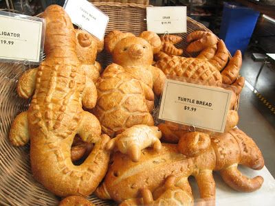 some bread shaped like animals on display in a store