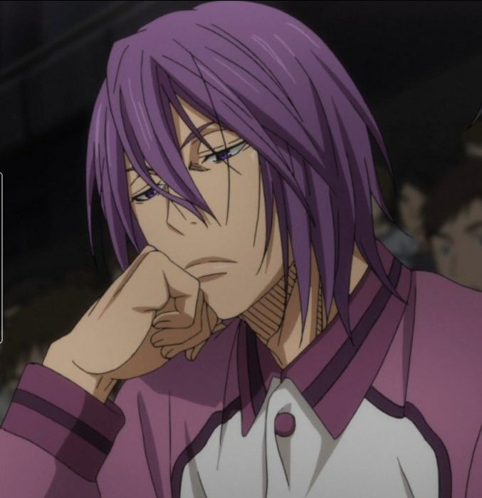 a man with purple hair and glasses is looking at something while holding his hand to his face