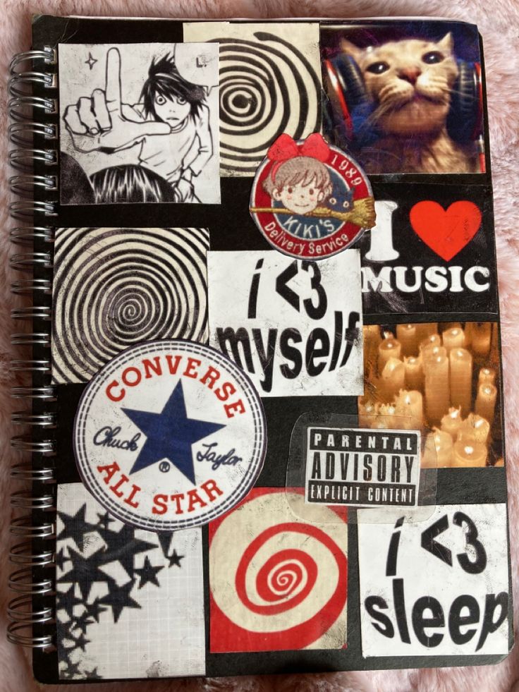 a spiral notebook covered in stickers and magnets