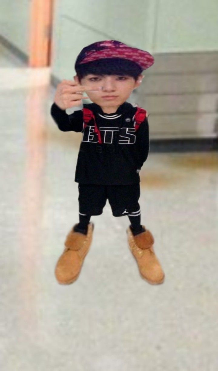 a little boy standing in the middle of an airport