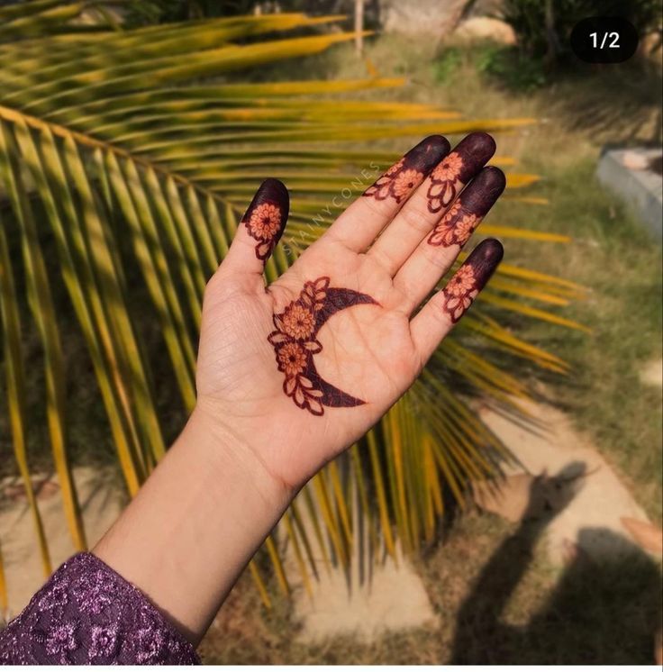 a woman's hand with hendix on it and palm trees in the background