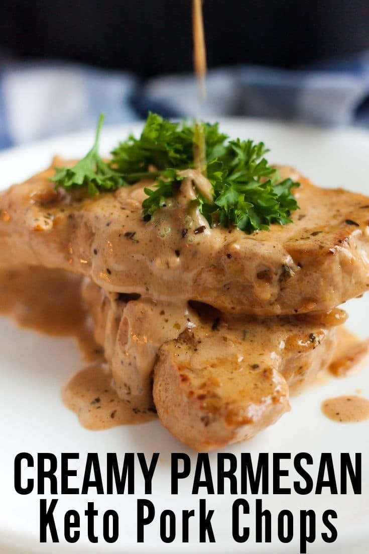 creamy parmesan keto pork chops on a white plate with sauce drizzled over them