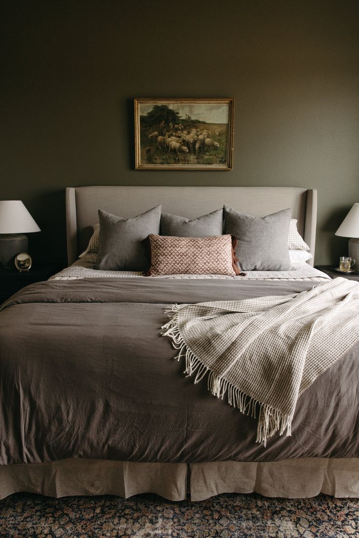 a bedroom with a large bed and two lamps