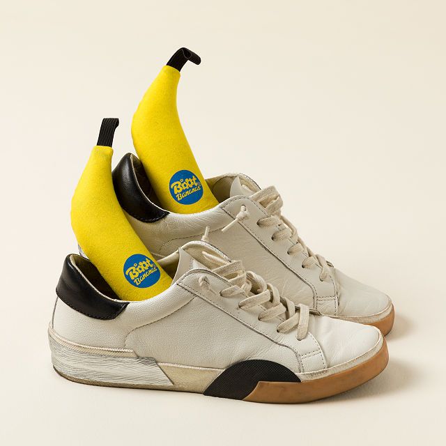 If your efforts to combat footwear funk have so far been fruitless, try going a little bananas. This pair of playful deodorizers efficiently eliminates unpleasant odors and adds sunny yellow cheer to your shoe-care routine. Plus, the banana design makes them the ideal shape to slide into all kinds of footwear, from flats to boots and everything in between.   Contains a blend of odor-neutralizing salts, minerals, and botanicals with a fresh fragrance of lavender, lemon, patchouli, and tea tree.  Designed to remove and prevent extreme and ingrained odors in sports shoes and boots. (Only intended for removing sweat and smells, not for drying drenched footwear.)  Can also be used to freshen gloves, sports gear, and any enclosed space. Just like real bananas, these will eventually “ripen” and t Natural Shoe Deodorizer, Banana Design, Photo Boots, Deodorize Shoes, Custom Flask, Cleaning Gift, Lavender Lemon, Ideal Shape, Uncommon Goods