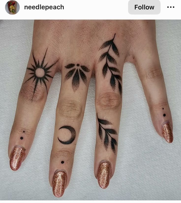 two fingers with different designs on them, one has a sun and the other is a moon