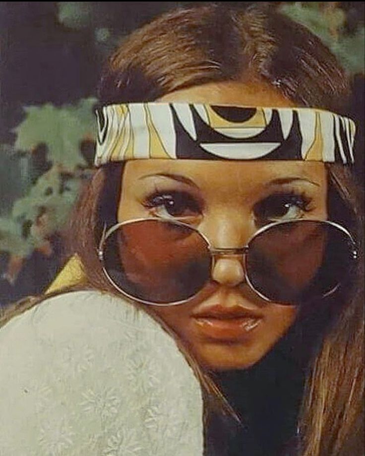 a woman wearing glasses and a headband with her eyes covered by the same fabric