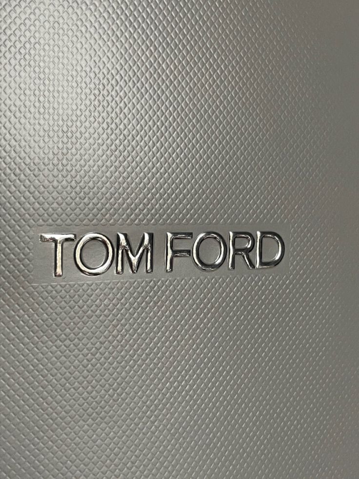 the word tom ford written in chrome on a metallic surface