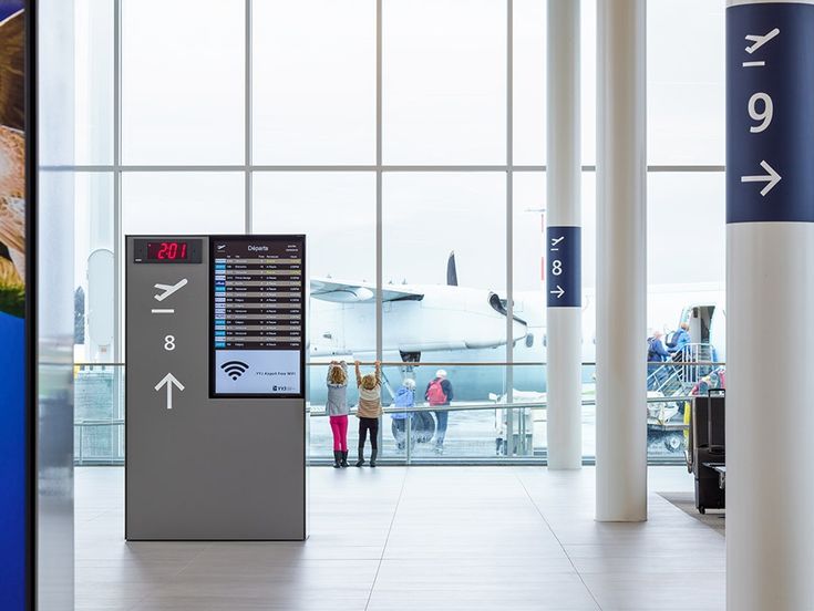 an airport terminal with people walking through it