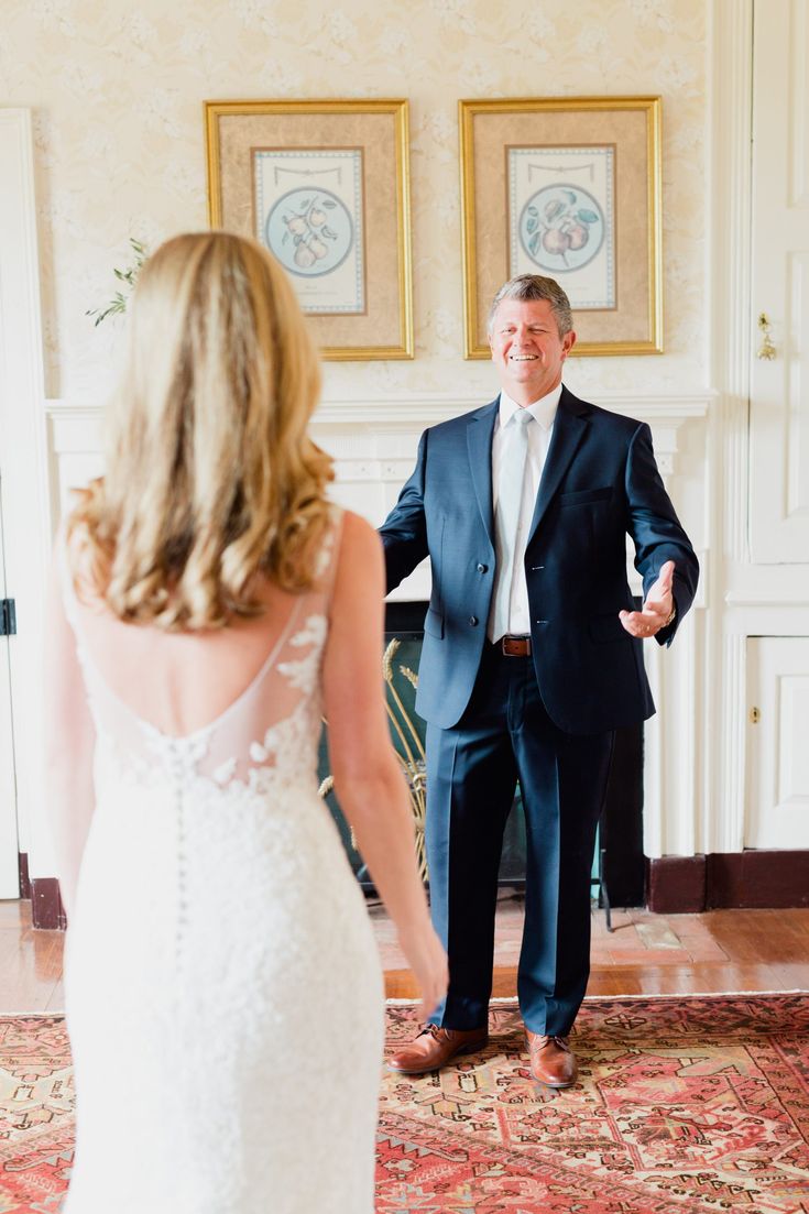 a man in a suit and tie standing next to a woman in a wedding dress