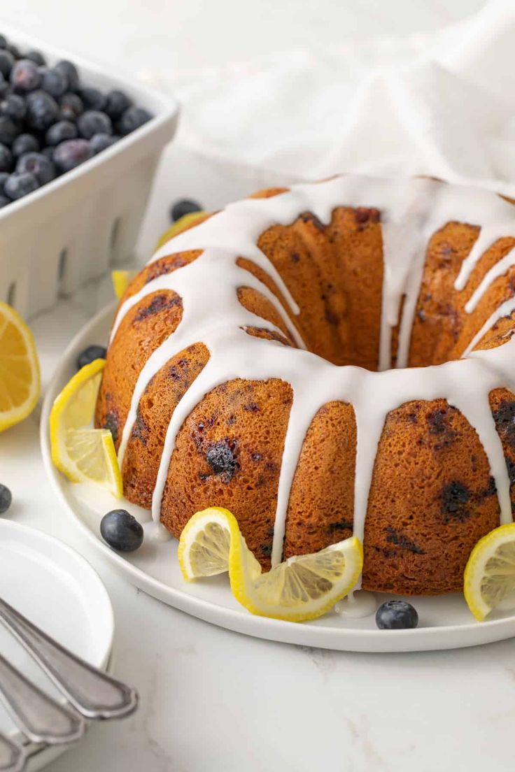 a bundt cake with lemon slices and blueberries