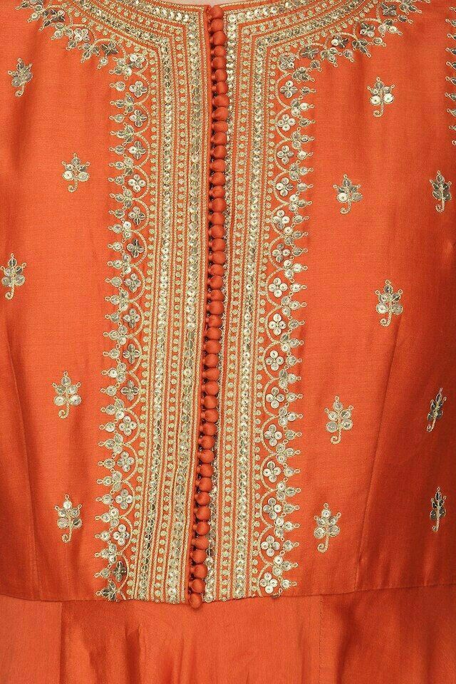 an orange dress with gold embroidered details