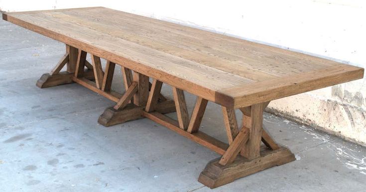 a wooden table sitting on top of a cement floor