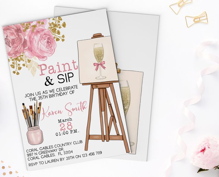 two pink roses are on the table next to an easel with paint and sip