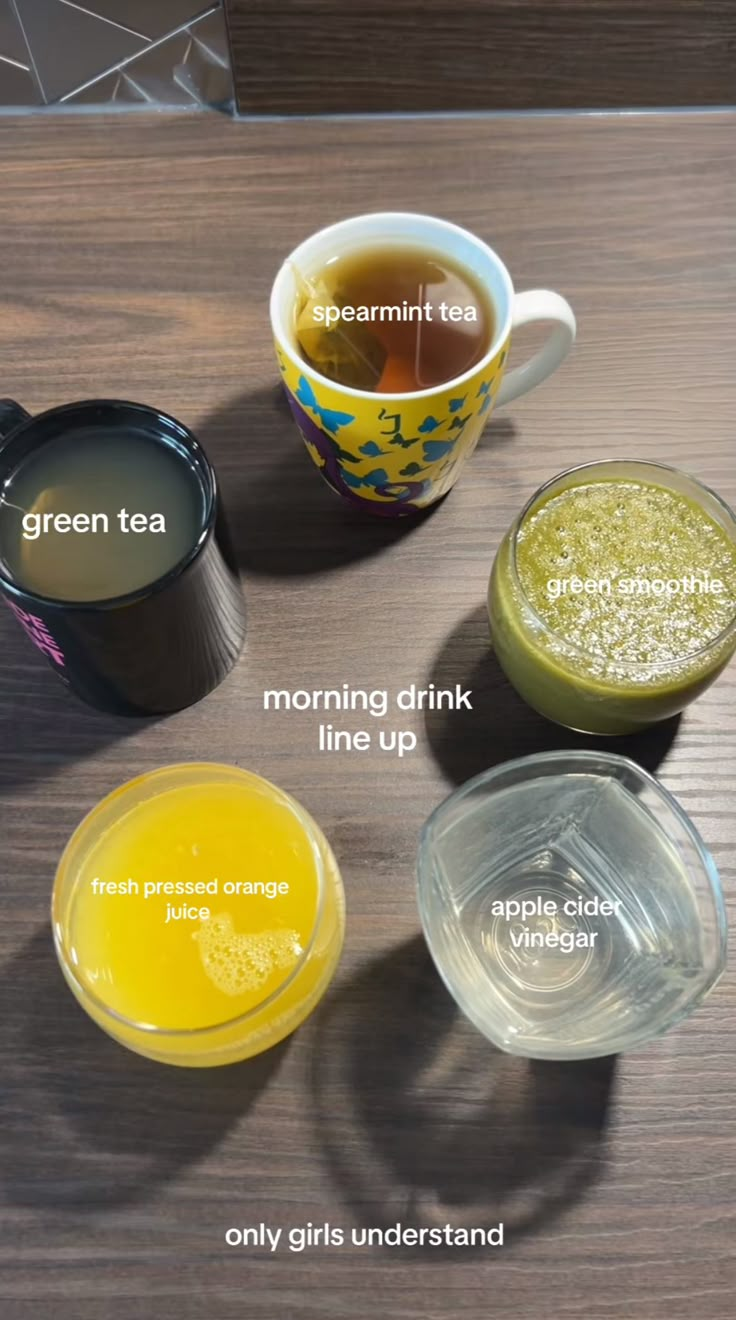 four different types of drinks on a table with their names in english and arabic, including green tea, morning drink, lemonade, apple cider