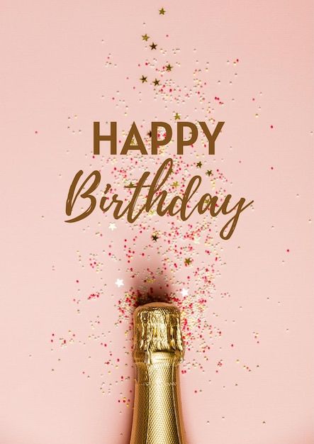 a bottle of champagne and some confetti on a pink background with the words happy birthday