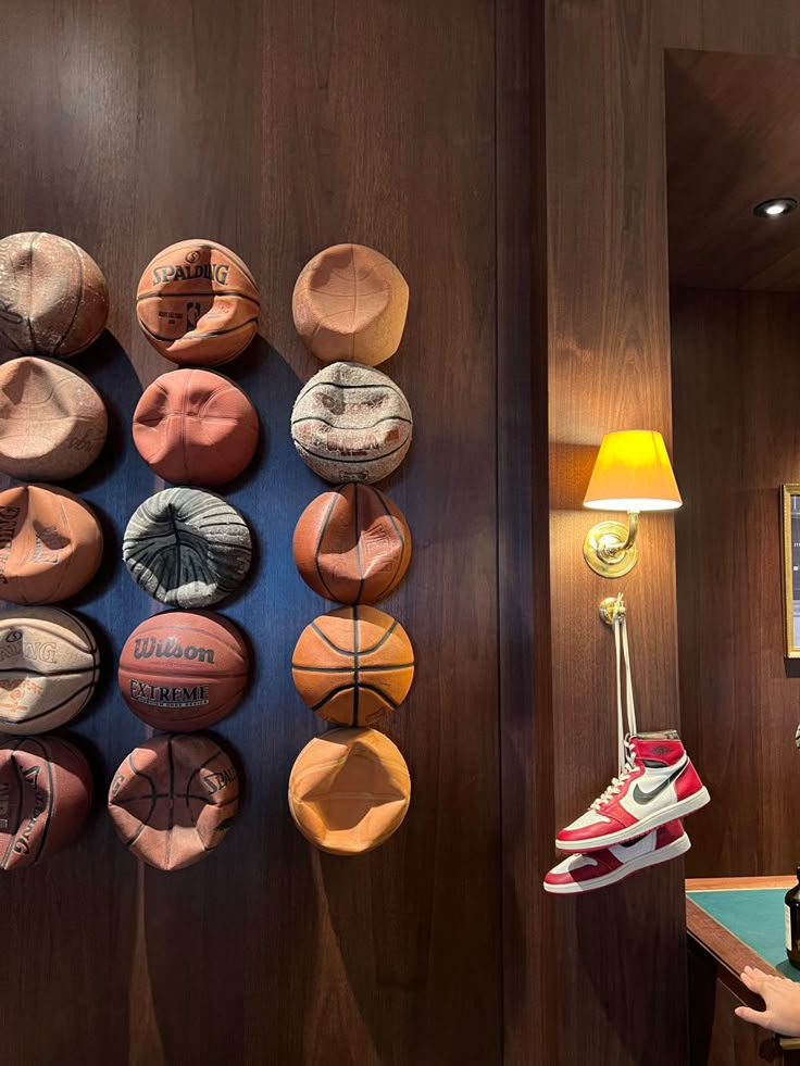 there is a wall with basketballs on it and a lamp next to the door