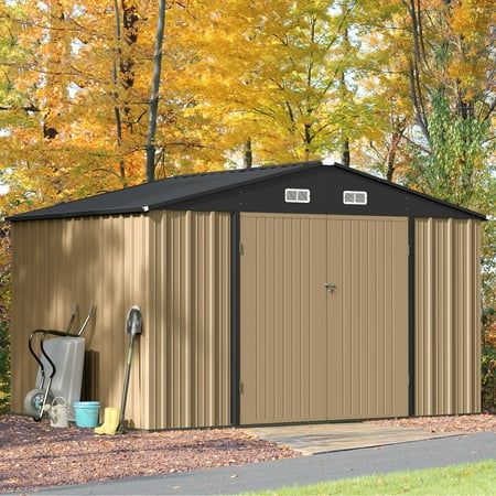 a metal shed in the middle of a park with autumn foliage around it and trees surrounding it