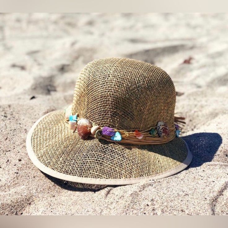 Seashells Seagrass Visor Sun Hat Seagrass Visor Hat Trim: Rustic Cord With Shells Brim: 4' Adjustable Inside Drawstring Bohemian Palm Leaf Hat Bands For Summer, Handmade Adjustable Mini Hats For Vacation, Adjustable Bohemian Panama Hat In Palm Leaf, Bohemian Palm Leaf Hat Bands For Vacation, Adjustable Bohemian Palm Leaf Hat, Adjustable Mini Hats With Curved Brim For Vacation, Natural Wide Brim Mini Hats For The Beach, Adjustable Toquilla Straw Festival Hats, Handmade Adjustable Sun Hat With Short Brim