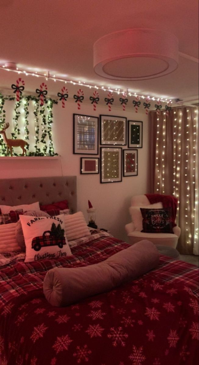 a bed room with a neatly made bed and christmas decorations on the wall above it